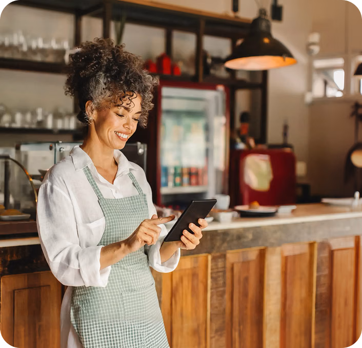 Restaurant owner with a tablet next to the Receptionist Agent screen showing 250 calls, 240 resolved by AI