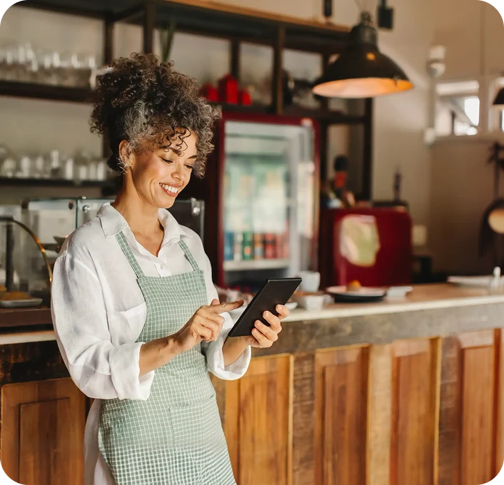 Restaurant owner with a tablet next to the Receptionist Agent screen showing 250 calls, 240 resolved by AI